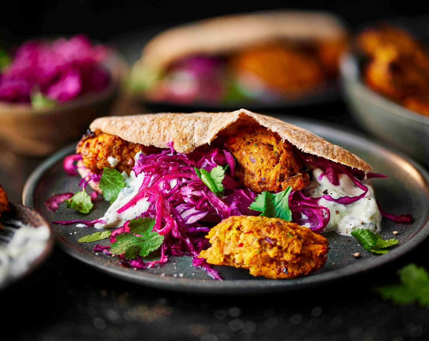 step 6 Toast the pitta breads (4) and serve filled with the falafel, slaw and tzatziki (100 g).