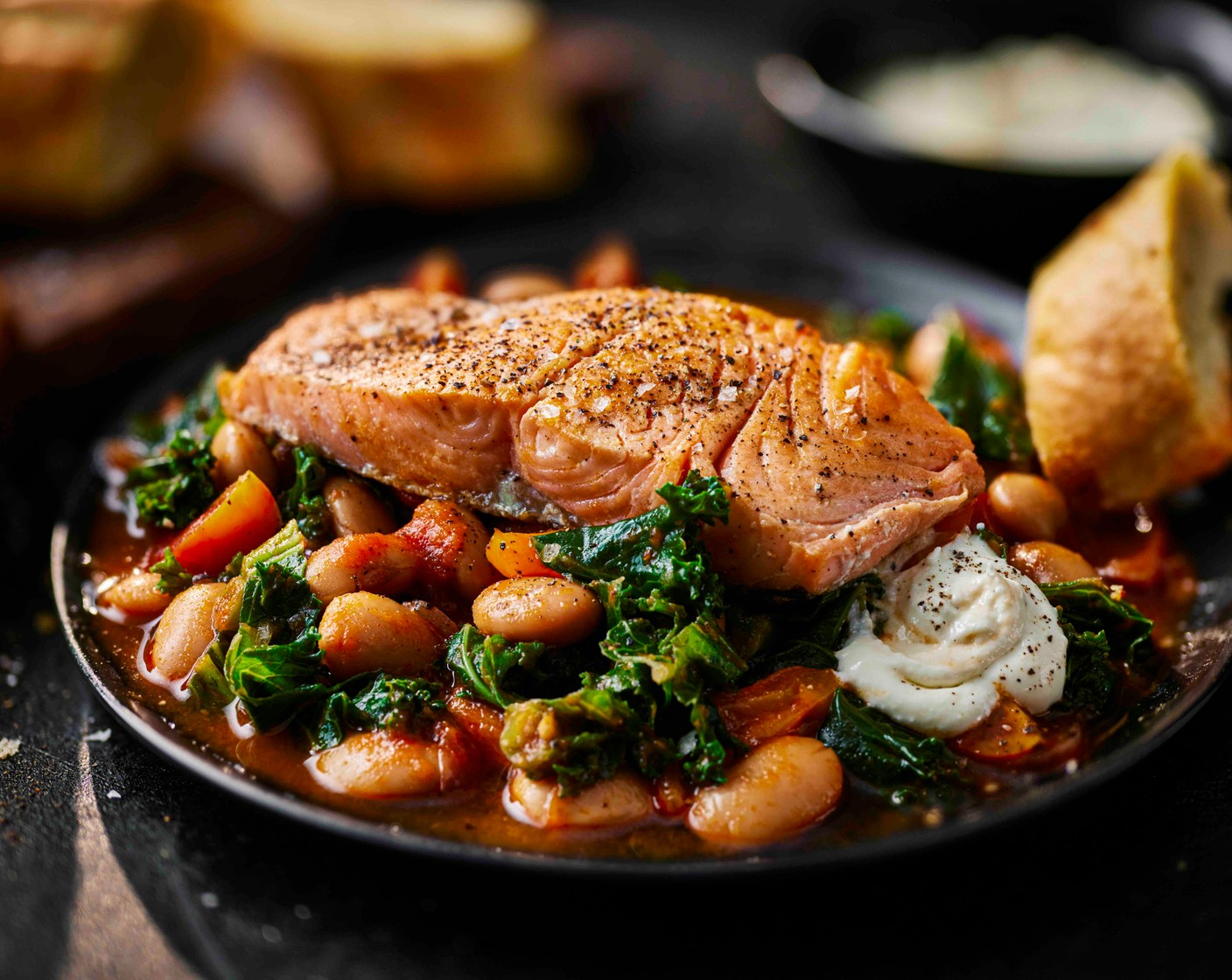 step 6 Plate the saucy beans with the salmon fillet on top; serve with a dollop of the soft cream cheese (as needed) (if you like) and the garlic bread for dunking.