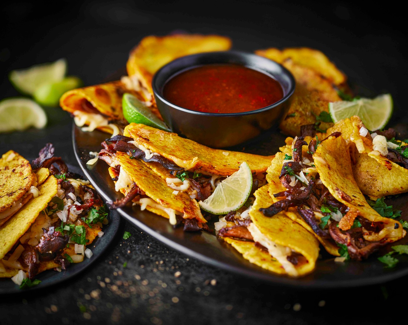 step 6 Serve the tacos with the reserved broth, diced onion (1), coriander (10 g) and lime wedges (2).