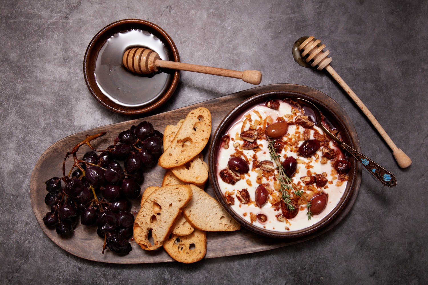 Honey whipped goat’s cheese, roasted grapes, chilli olives and bruschettine