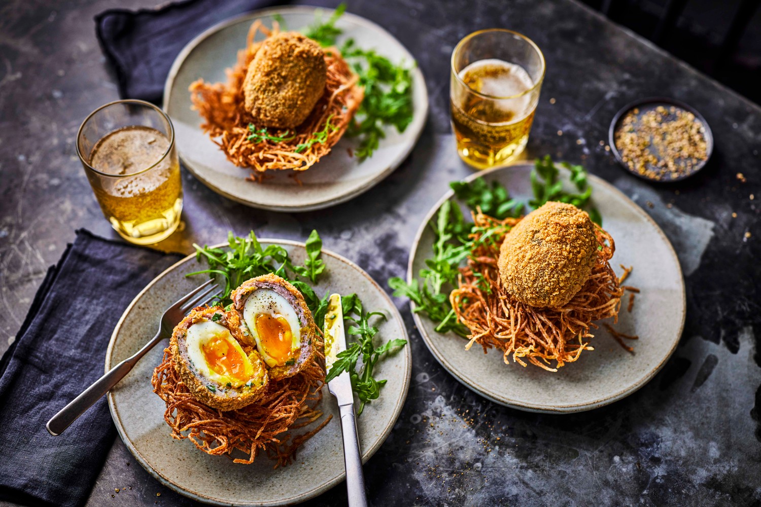 Scotch eggs on potato nests