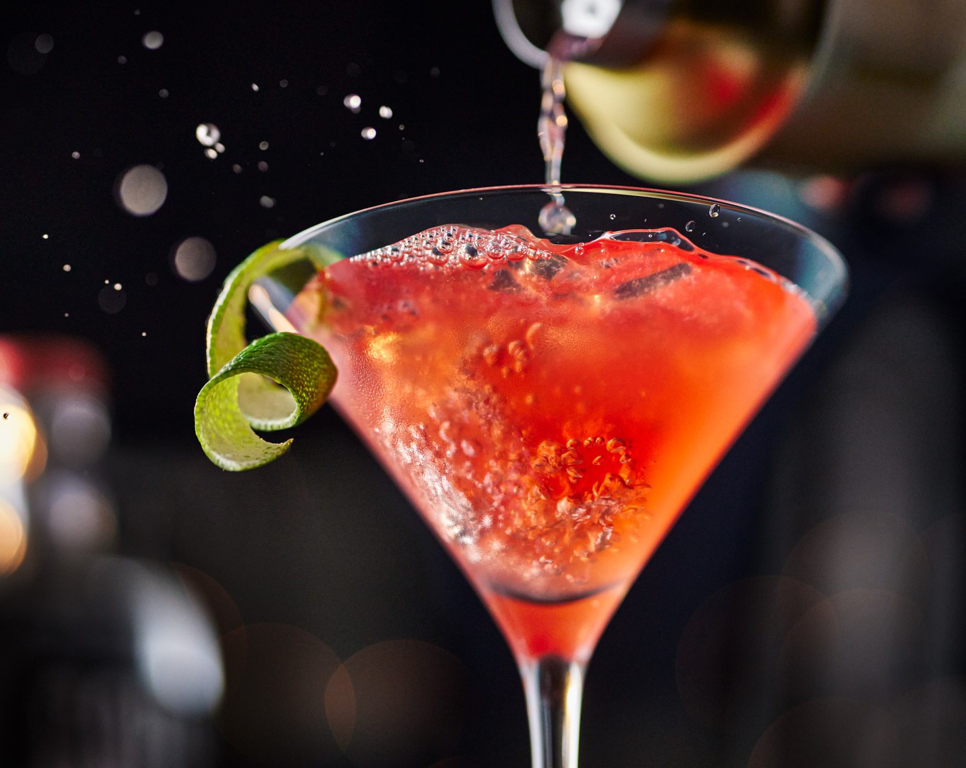 step 3 Gently shake before pouring into a cold martini glass. Garnish with the lime peel.