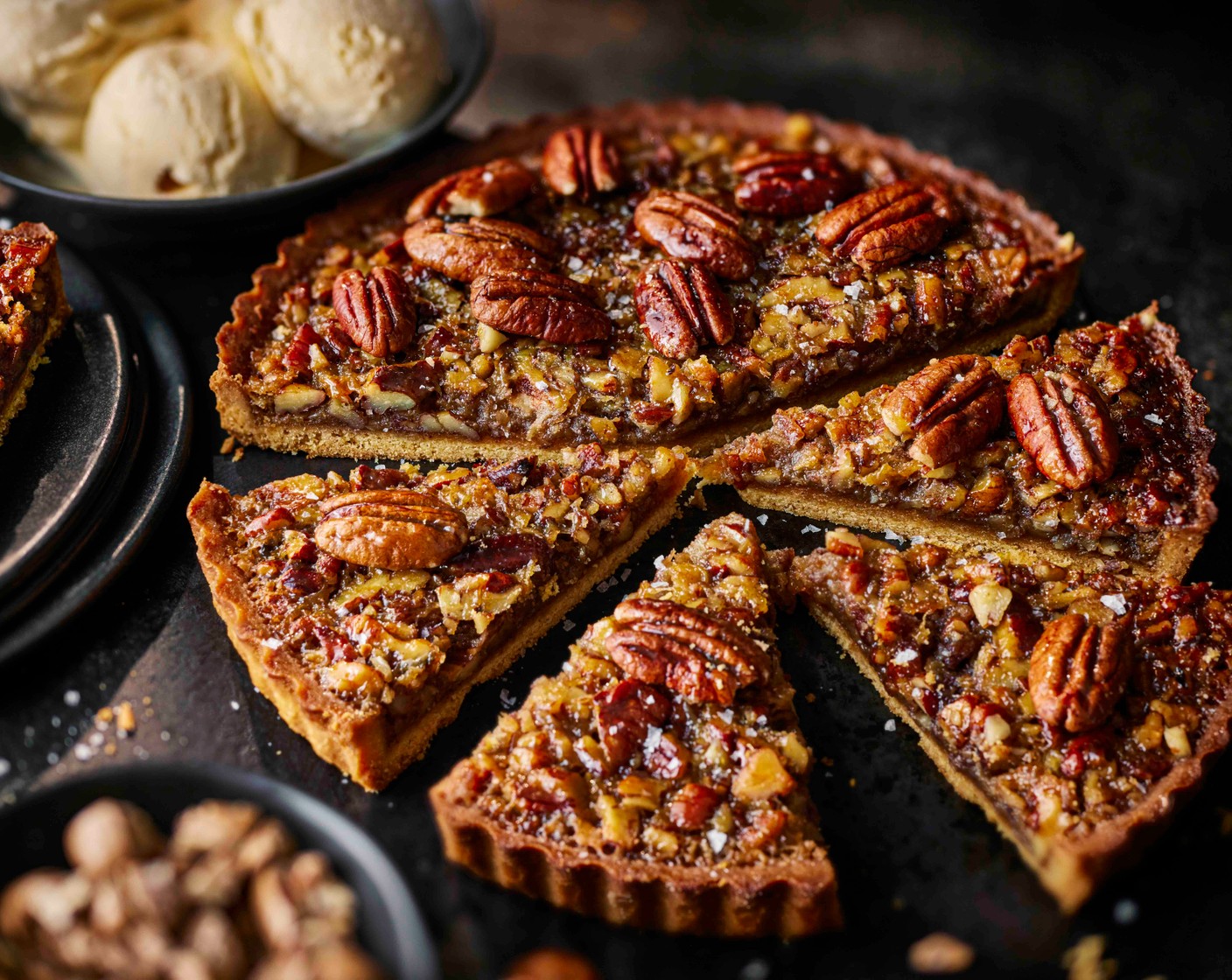 step 5 Allow to cool completely. Cut the pie into slices and serve with a scoop of vanilla ice cream (as needed), topped with chopped blond pecans (as needed) and a touch of flaky sea salt.