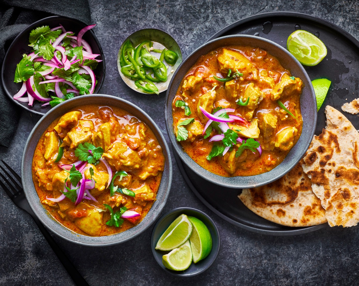 step 7 Plate up the curry and garnish with the green chillies (3), then serve with the salad, lime wedges (2) and roti (1).