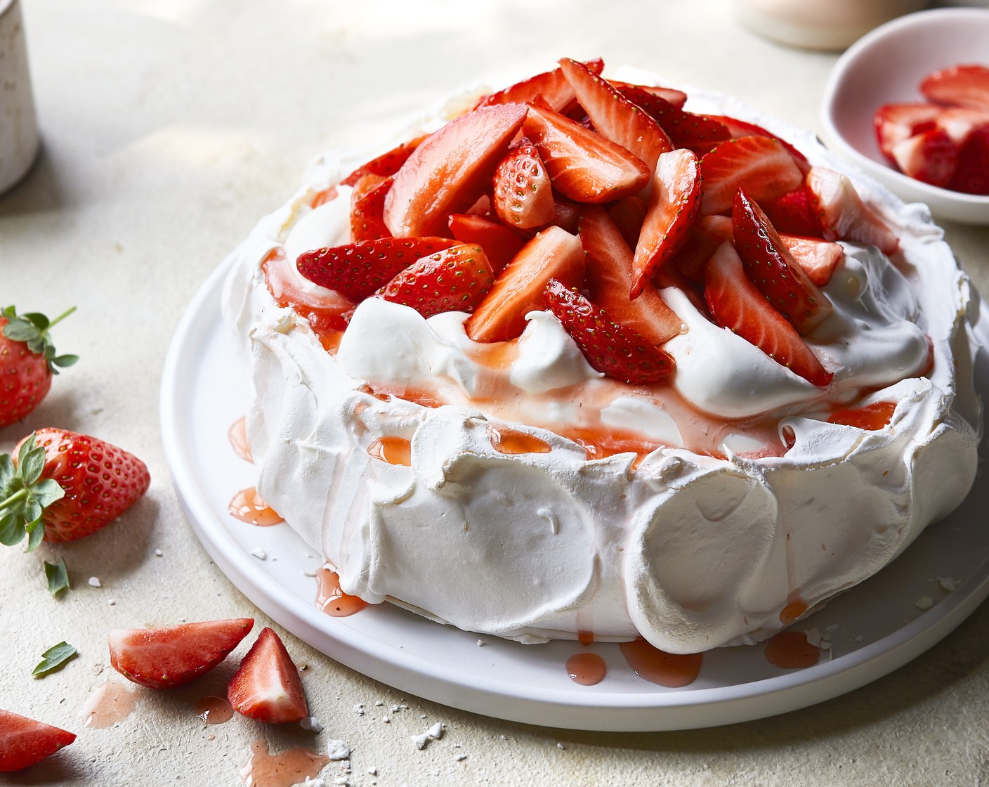 step 6 Whisk the double cream (300 ml) to soft peaks then pour in all the liquid from the strawberries and fold through. To serve, spoon the cream into the centre of the cooled pavlova and top with the strawberries.