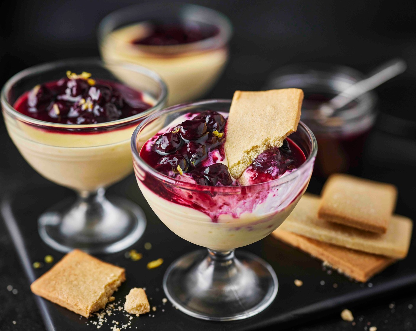 step 5 For the compote, put the blueberries (190 g), sugar (2 tbsp), lemon juice (1/2) and cordial (3 tbsp) in a saucepan. Avoid stirring and leave to simmer for 8-10 minutes until the blueberries are plump and glossy. Leave to cool completely. Spoon the cooled compote over the set possets and serve with the biscuits.