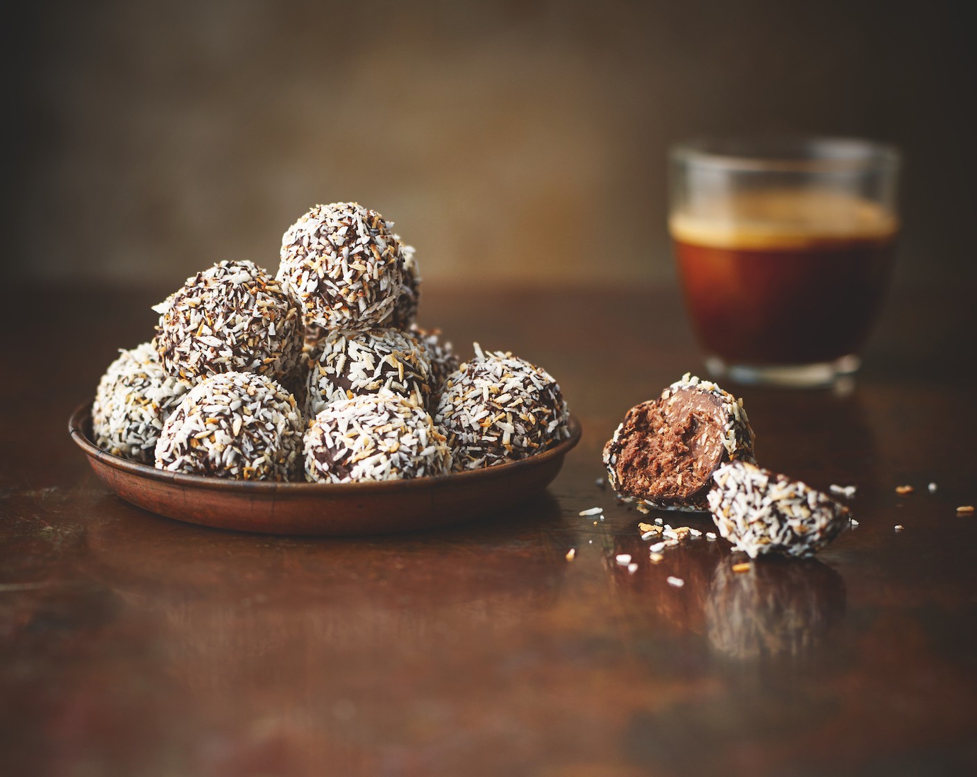 step 5 Carefully drop one truffle into the melted chocolate and gently roll around with a fork until coated. Lift out of the chocolate with the fork, tapping the fork against the side of the bowl to remove excess chocolate, then drop into the toasted coconut to coat. Repeat with the remaining truffles. Chill for 30 minutes before serving.