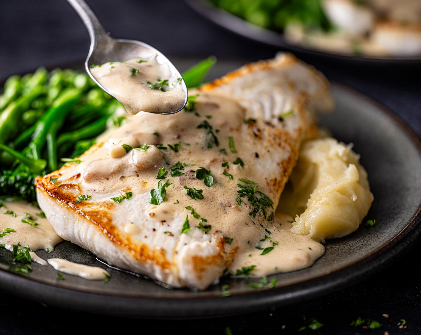 step 7 Add the mash to the plate and top with the fish and the veg on the side and spoon over the creamy sauce and sprinkle with a little parsley to garnish.