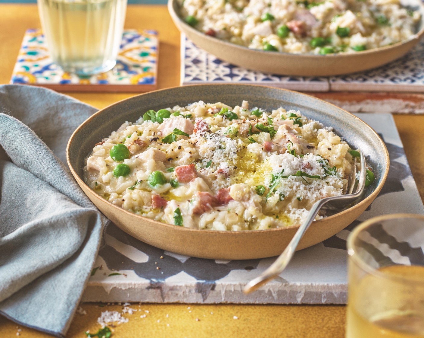 step 3 Serve the risotto in warmed bowls and top with the parsley (1 handful) and plenty of grated parmesan (to taste). Drizzle over some lemon-infused olive oil (to taste) to serve, if you like.