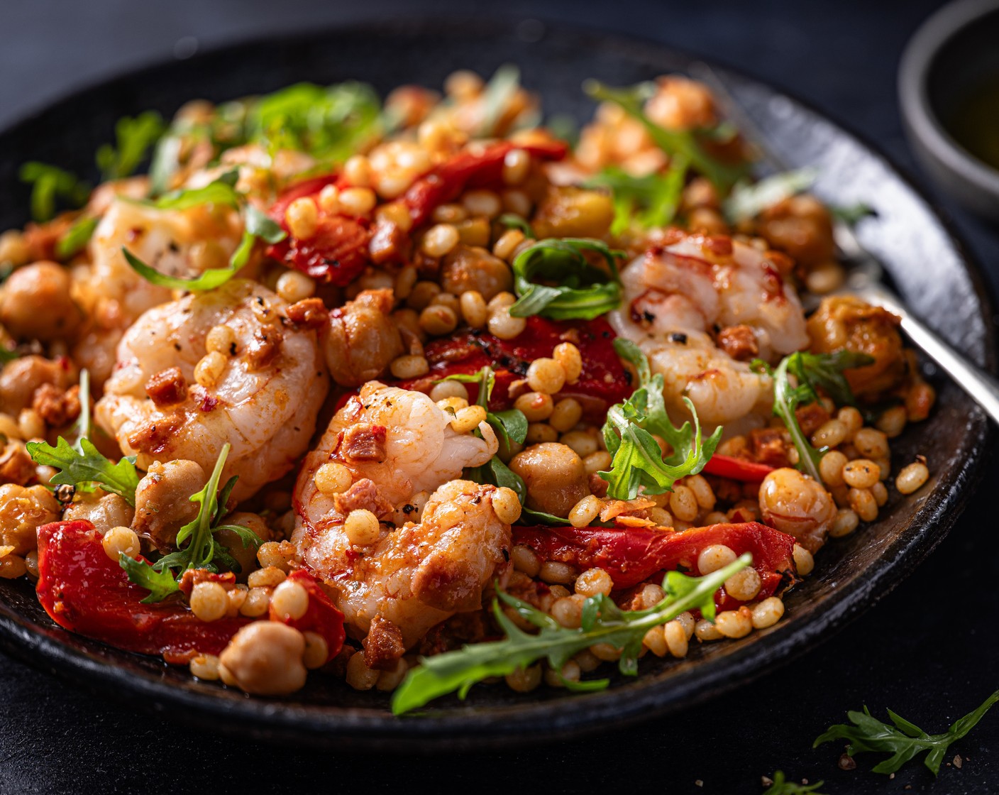 step 4 Toss the rocket (1 handful) through the couscous and top with the prawns.