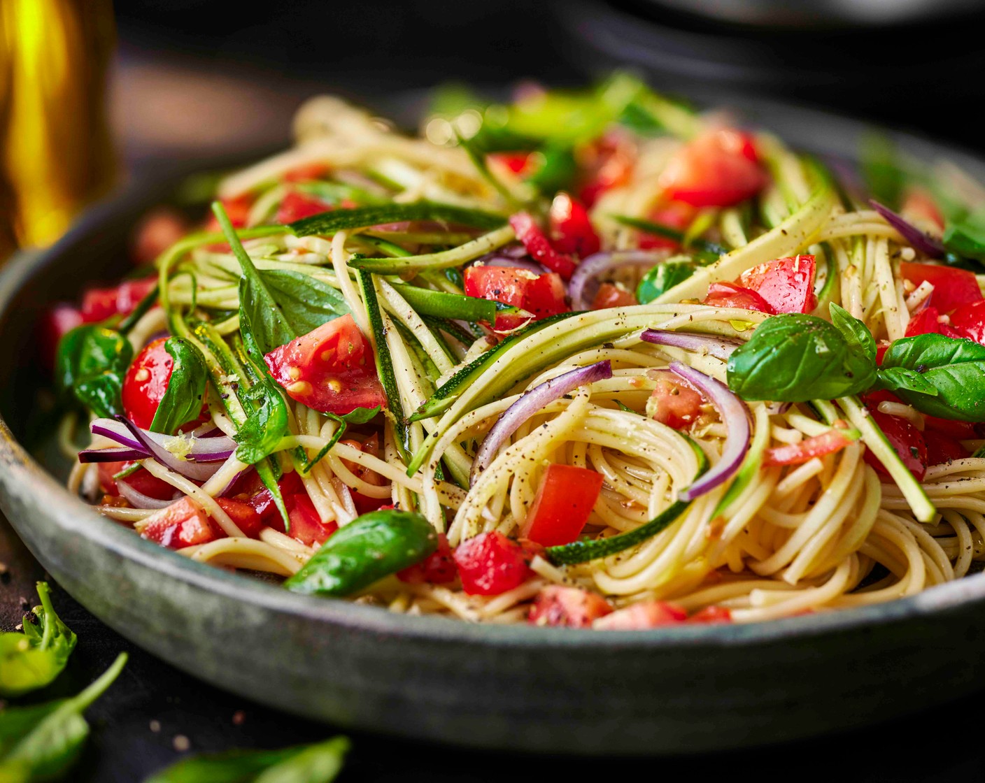 step 3 Drain the pasta, reserving a cup of the cooking water, and toss through the tomatoes and courgettes. Add a small splash of pasta cooking water if needed to loosen. Serve with extra fresh basil, the reserved lemon zest, and a drizzle more lemon oil on top.
