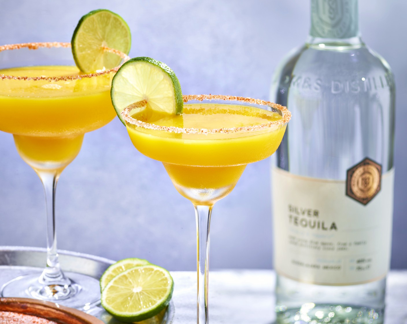 step 2 Add the lime juice (2 tsp), distilled silver tequila (25 ml), freshly squeezed orange Juice with crushed mango (100 ml) and orange liqueur (15 ml) to a shaker with a handful of ice. Shake and strain into a glass and garnish with a slice of lime (to taste).