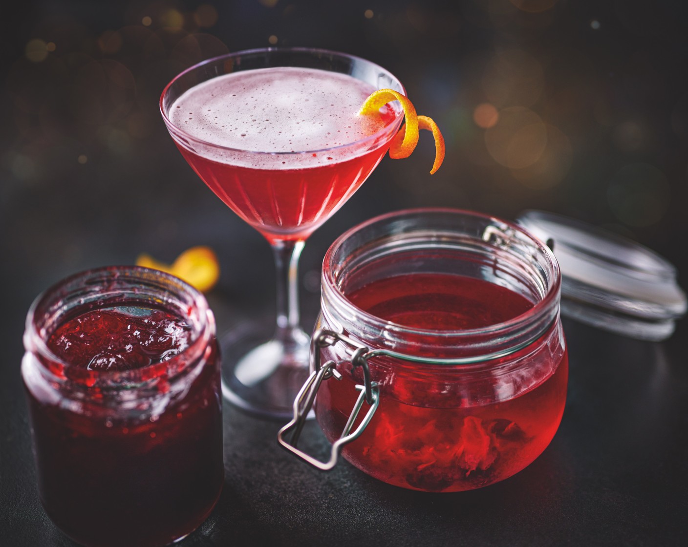 step 2 To make the cherry Cosmo, add the infused vodka (40 ml), orange brandy liqueur (25 ml), lime juice (1/2) and cranberry juice (50 ml) to a cocktail shaker with a handful of ice. Shake then strain into a martini glass. Garnish with a twist of orange zest (as needed).