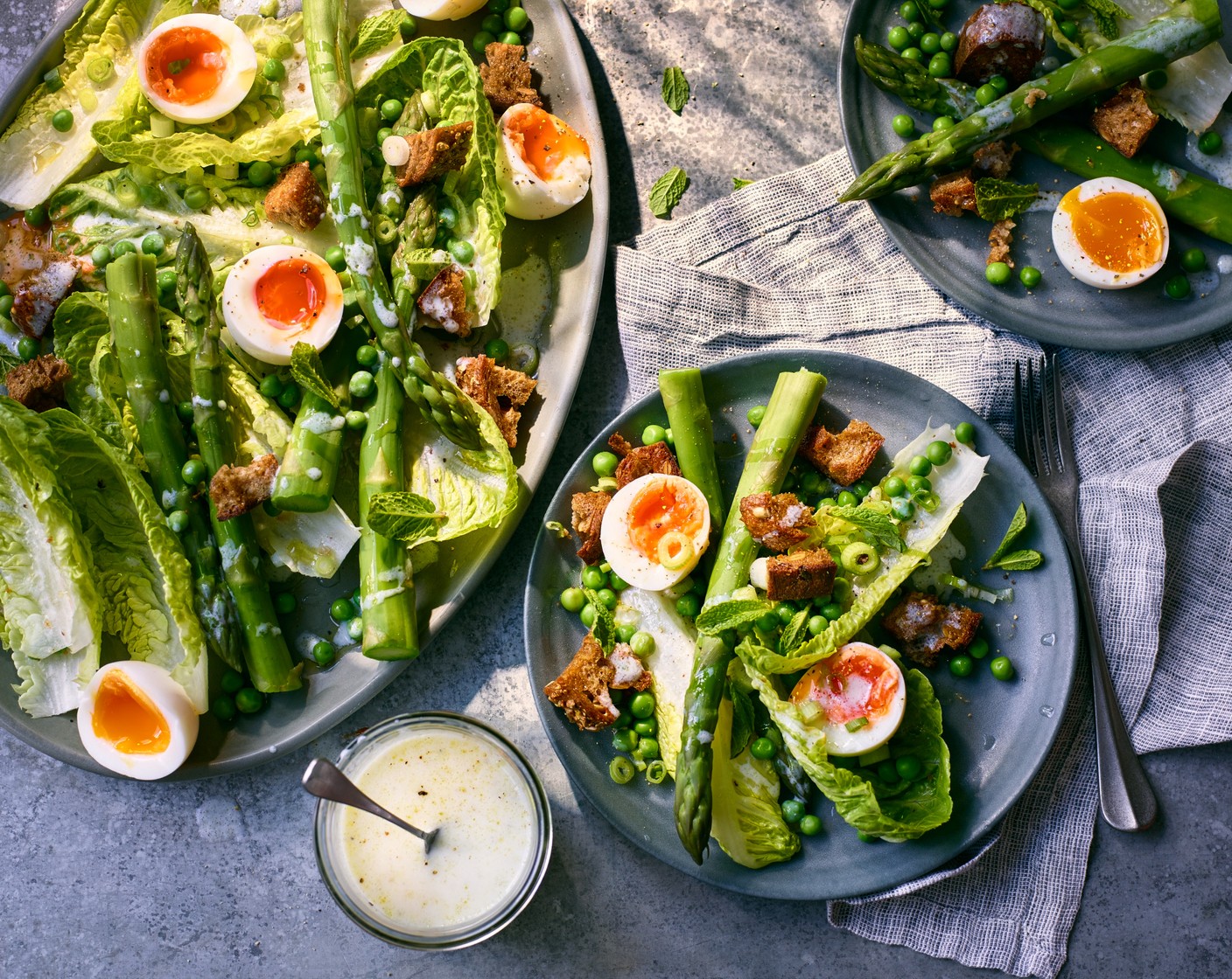 step 6 When you’re ready to serve, toss the M&S sweet gem lettuce (1 head), cooked asparagus and peas with the croutons and the dressing in a bowl. Tumble everything onto a serving platter and scatter with the M&S spring onions (5) and mint (1 bunch). Arrange the eggs on top, seasoning each with salt and pepper. Serve as a side to a roast chicken or as a light lunch.