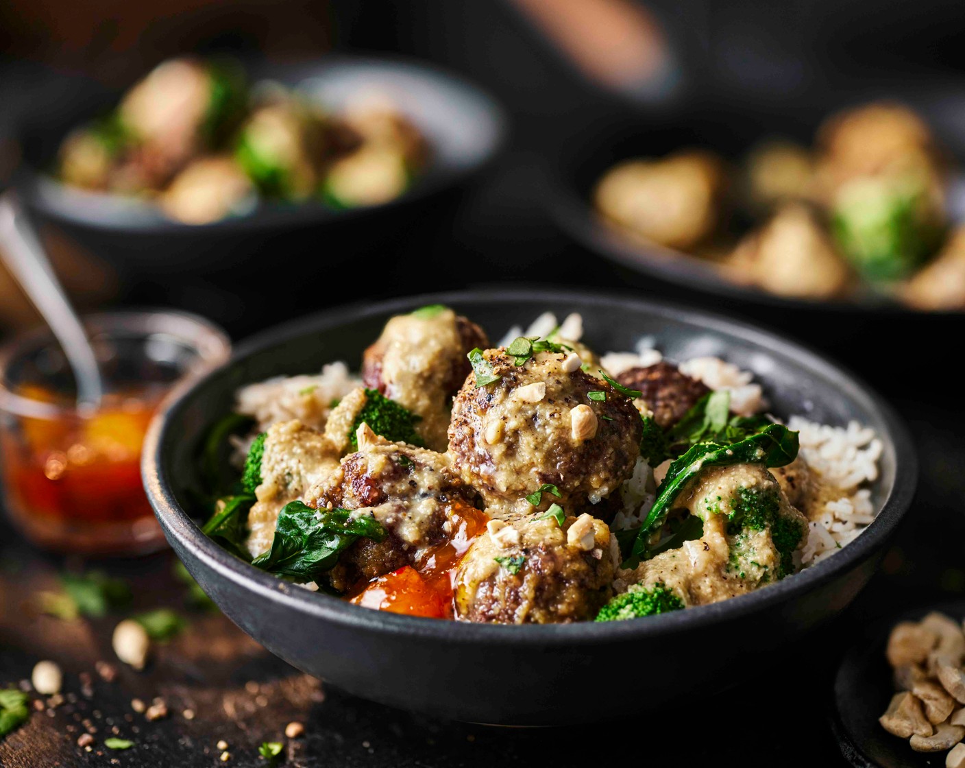 step 10 Divide the coconut rice between bowls, spoon over the korma meatballs and vegetables, then scatter with the fresh coriander (1 handful) and cashews (40 g) to serve. Serve with dollops of mango chutney (as needed), if you like.