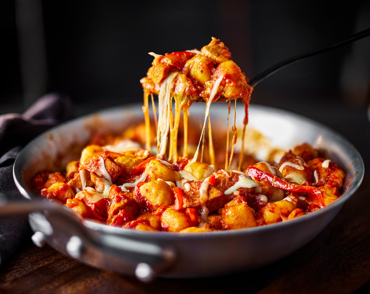 step 4 Stir the drained gnocchi through the chicken and pepper sauce and mix well to coat. Remove from the heat and top with the grated cheddar and mozzarella (100 g). Pop into the oven for 20-25 minutes, until the gnocchi is tender and the chicken is cooked through.