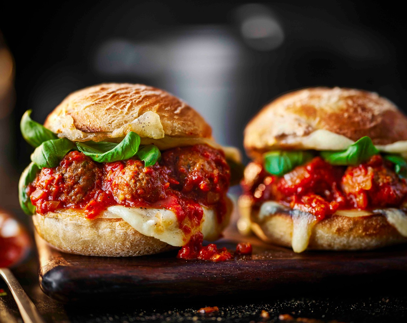 step 5 Spoon five meatballs onto each base, scatter with basil and finish with the tops.