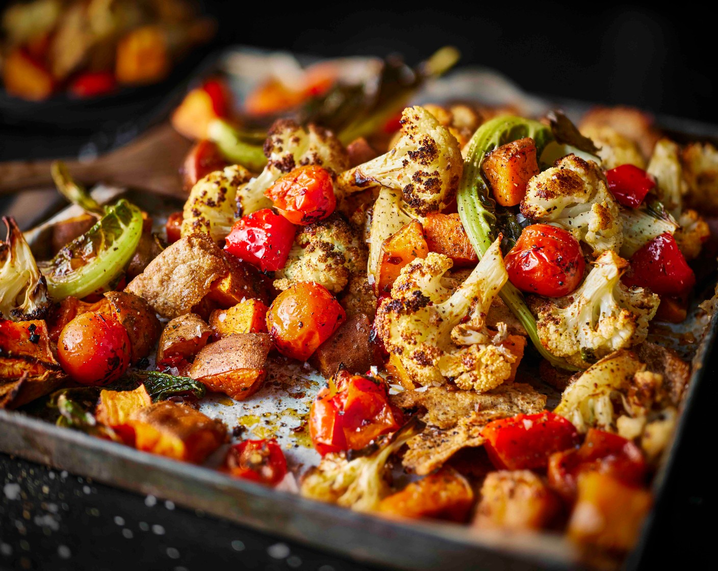 step 3 Roast for 20 minutes, then remove from the oven and stir in the cherry tomatoes (150 g) and fajita seasoning (2 tbsp). Scatter the pitta pieces (3) on top and drizzle with oil. Nestle in the cauliflower leaves. Return to the oven for a further 10-15 minutes until the pitta chips are crisp and the potatoes have broken down, then serve.