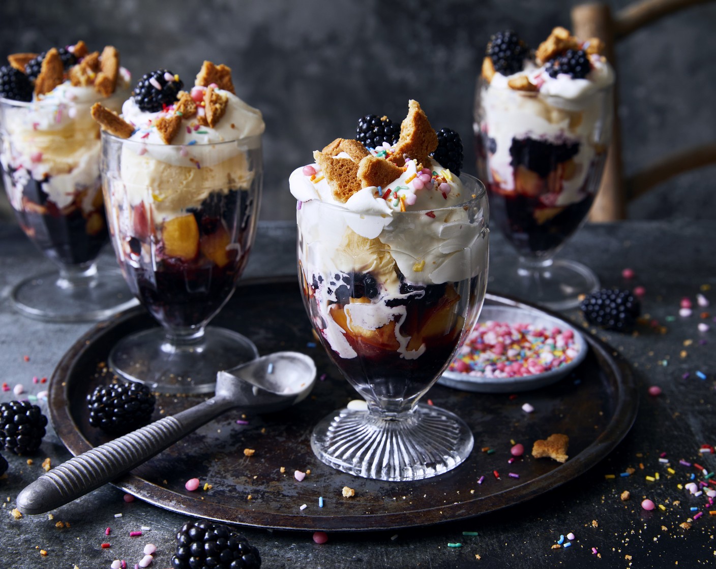 step 4 Add a generous scoop of vanilla ice-cream (1 tub) to the sundae glass along with a dollop of whipped cream, the crumbled ginger snaps (4), reserved blackberries. Finally top with Percy sprinkles (to taste).