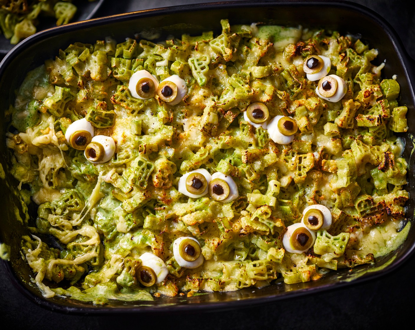 step 6 Once the monster mac and cheese is baked, top with the mozzarella eyeballs and dig in.