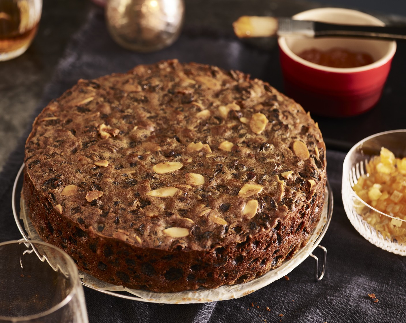 step 7 Make small holes across the surface of the cake using a clean skewer. With a pastry brush, brush over 50ml brandy until it soaks into the cake. Wrap it tightly in a double layer of parchment paper and foil, then store in a cool, dry place until required.