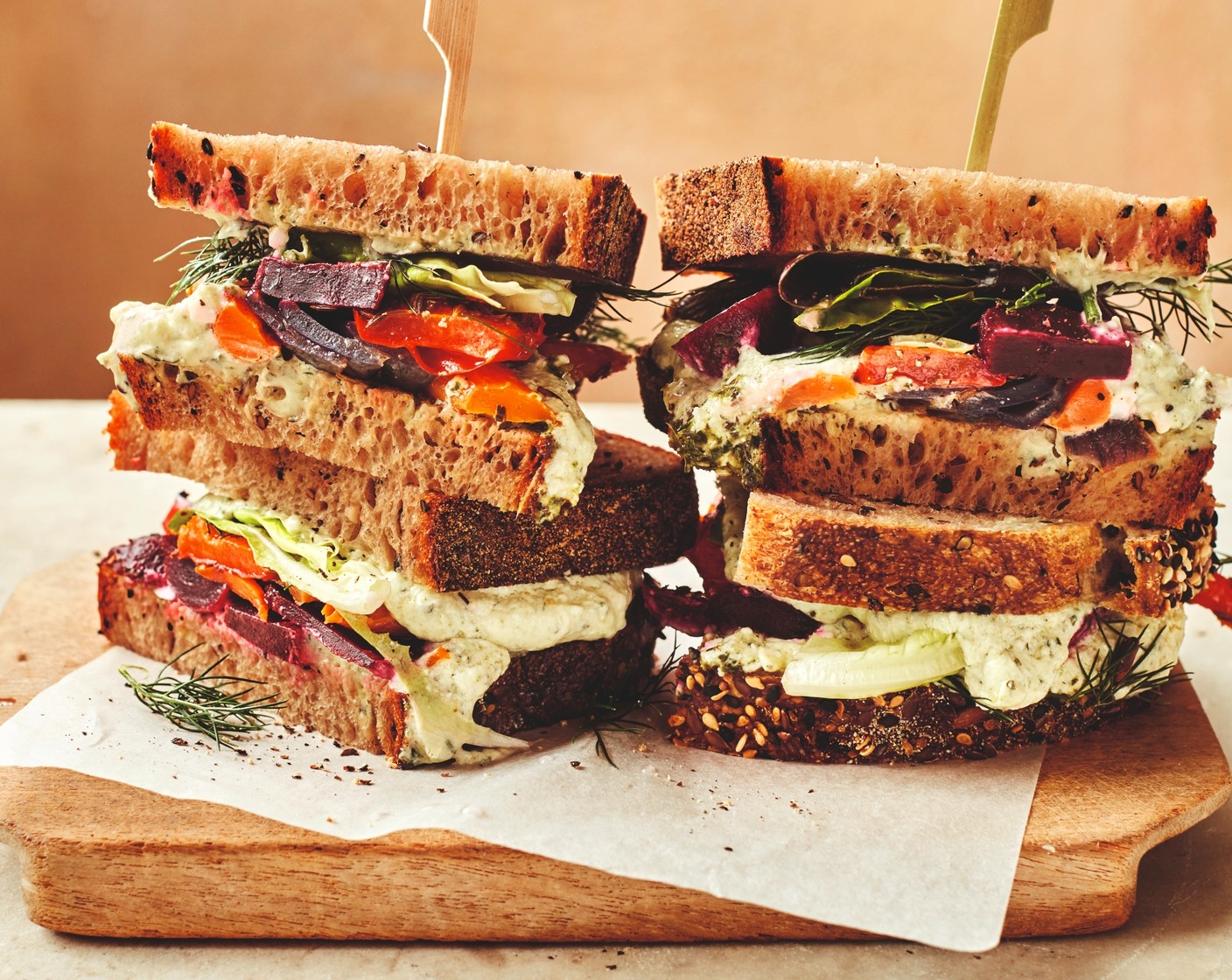 step 2 To assemble the sandwiches, spread each slice of Collection crafted seeded sourdough (8 slices) with a spoonful of the green herby feta dip (100 g). Layer on the beetroot (1 pack), roasted vegetables, salad leaves (1 handful) and dill (1 handful). Top with the remaining sourdough.