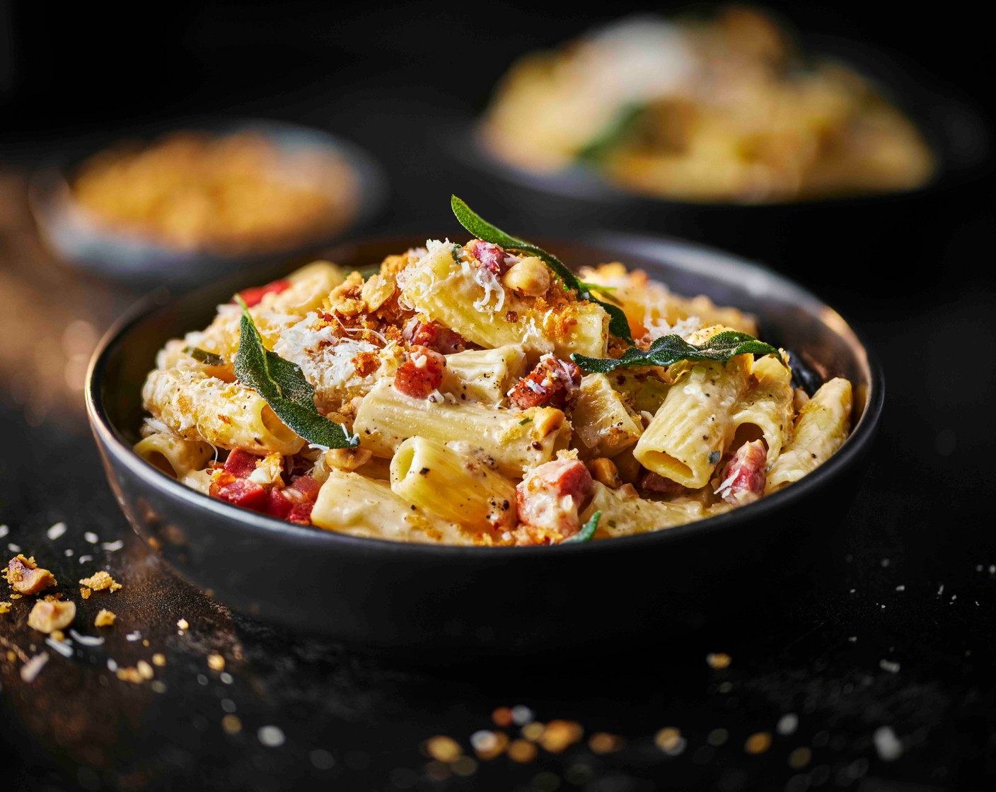 step 5 Drain the pasta with a slotted spoon into the creamy sauce along with two thirds of the Parmesan (20 g), the pancetta and a ladle of pasta cooking water. Spoon into bowls and top with the breadcrumbs, remaining Parmesan and crispy sage leaves.