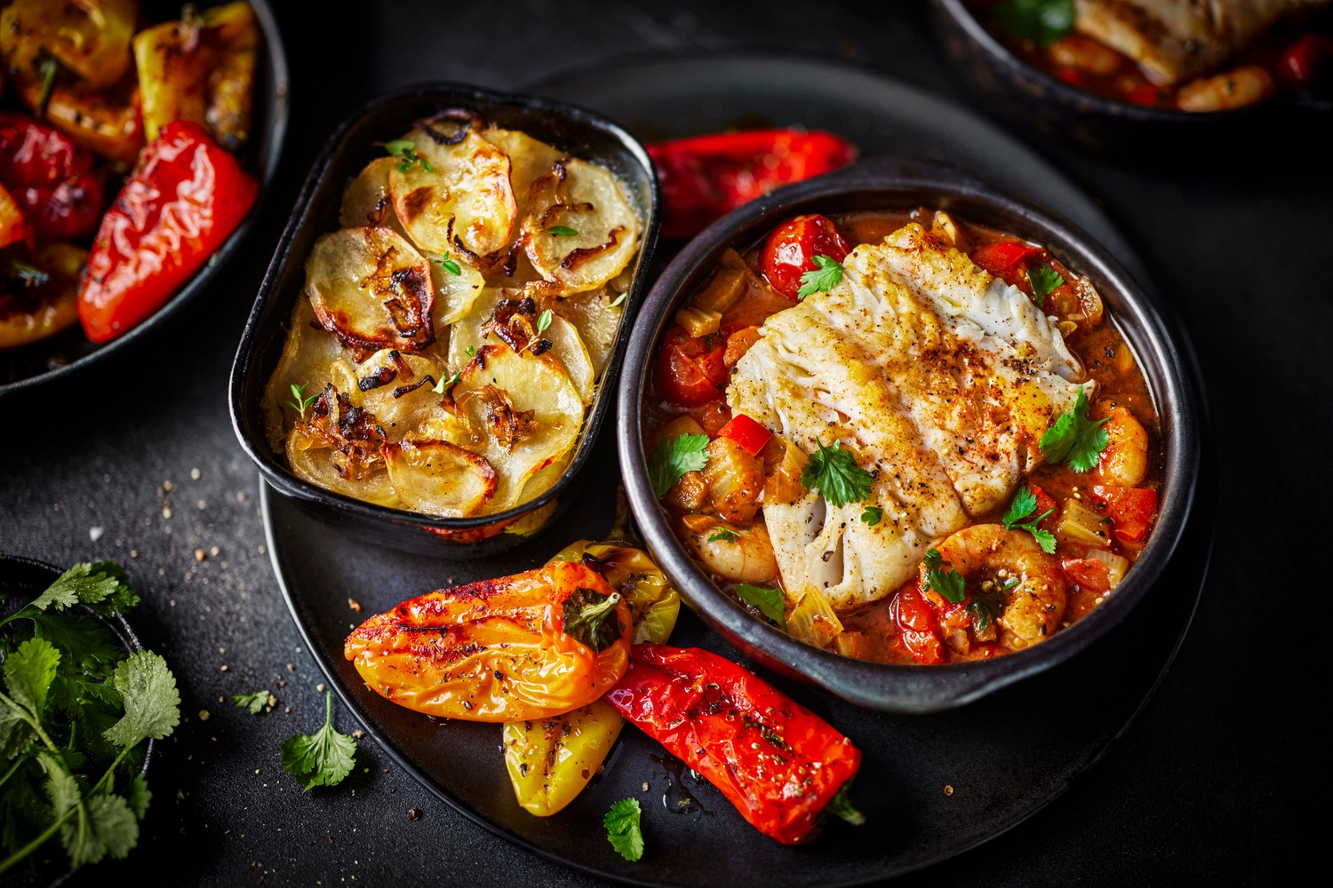 Pan-roasted salt cod with bouillabaisse sauce and roasted baby peppers
