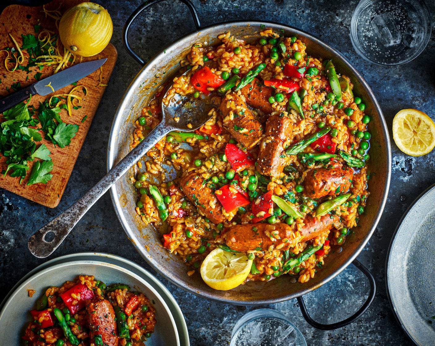 step 5 Divide the paella between serving dishes. Finish each with a scattering of the parsley (25 g), a sprinkling of the M&S Remarksable Value lemon (1) and a squeeze of the juice.