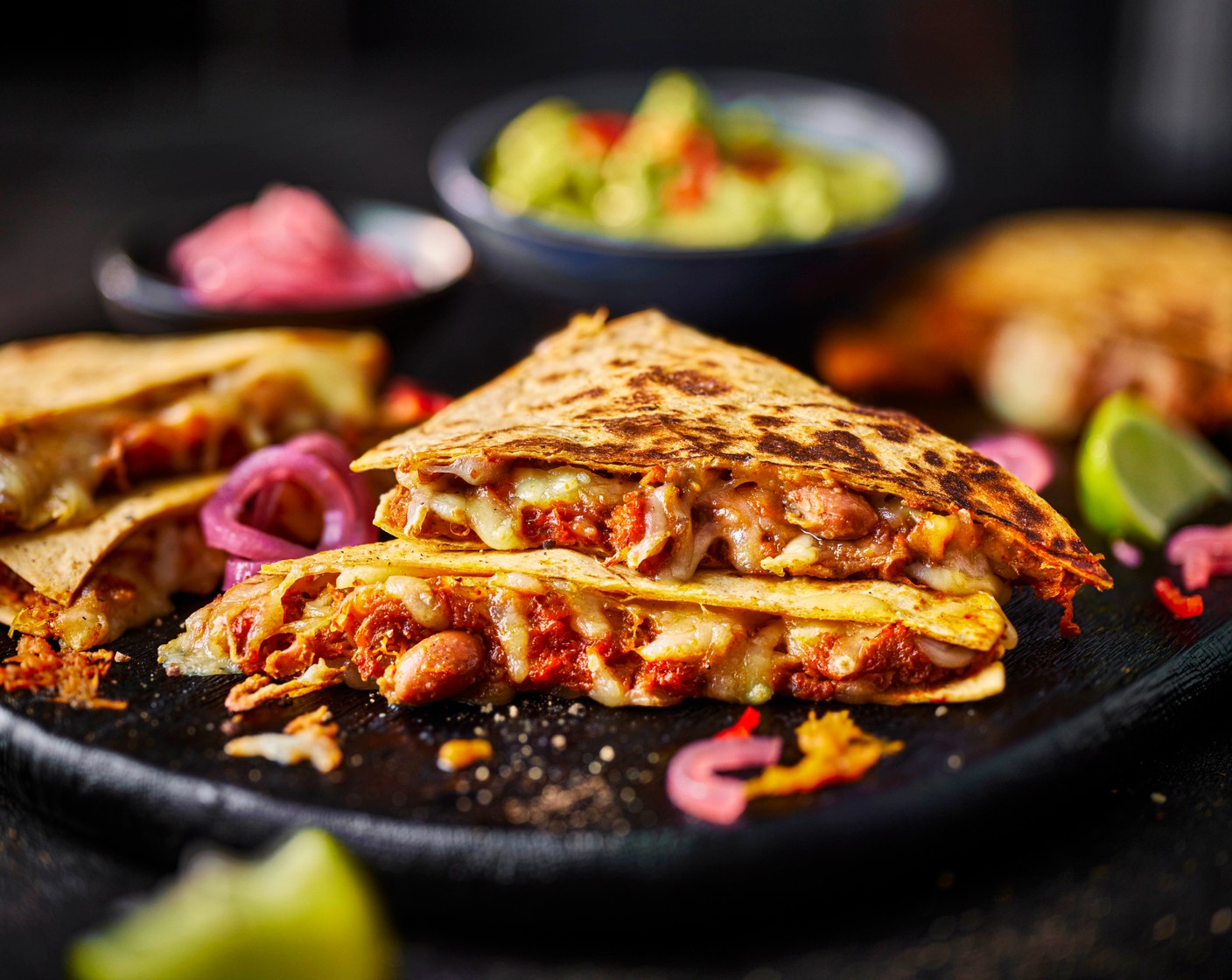 step 5 Cut each quesadilla into 6 triangles and serve with the guacamole (100 g).