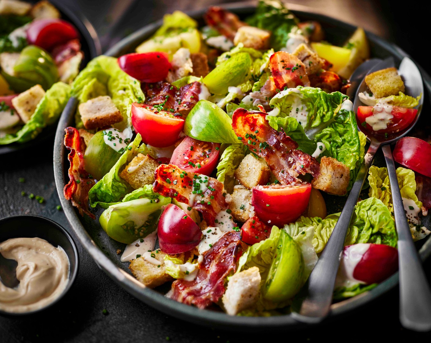 step 5 Add the lettuce (2 heads) to a large serving platter and top with the tomatoes. Tear the bacon over the salad and scatter with the croutons. Drizzle over the dressing and scatter over the chives (15 g).