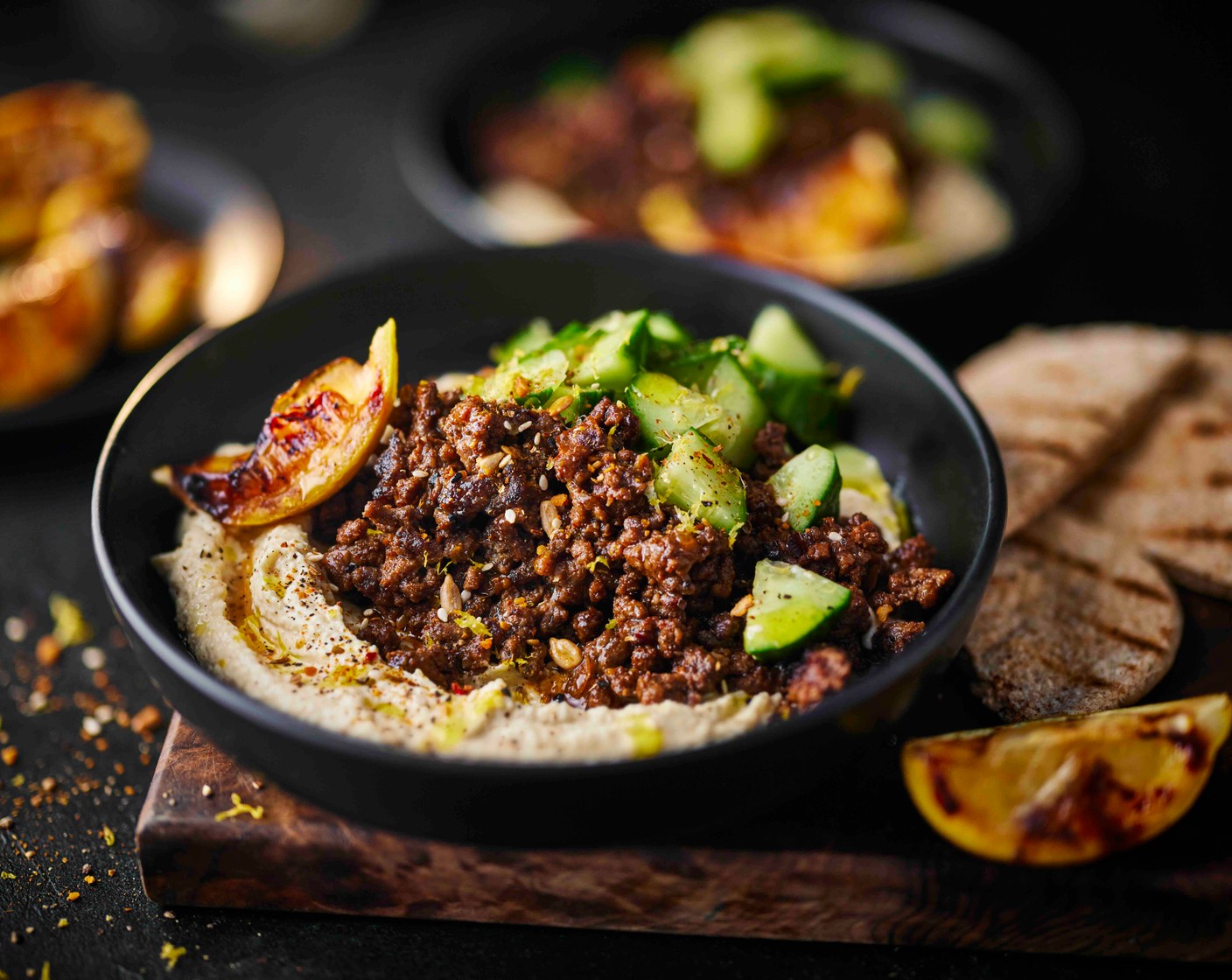step 4 Spoon the houmous (1 tub) into four bowls. Spoon the mince on top, followed by the cucumber salad and the crunchy topper from the shawarma kit. Serve with the pitta breads and the charred lemon wedge.