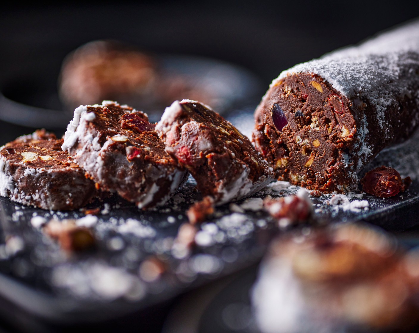 step 5 Once set, unravel the salami log and sift the icing sugar over the top. Using clean hands, rub the icing sugar (15 g) into the chocolate log, coating the sides and bottom. Cut into slices and serve.