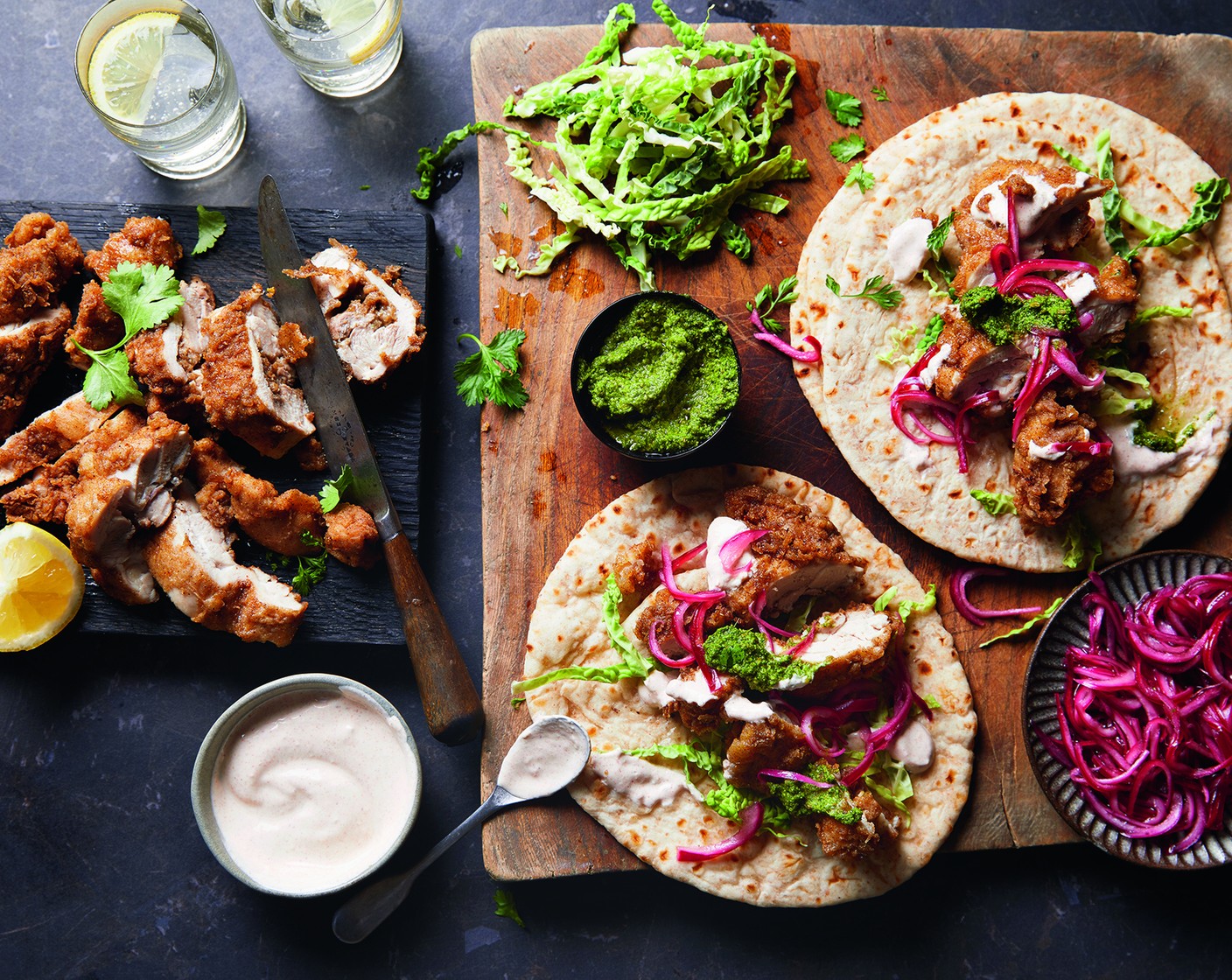step 10 To serve, place a roti on the plate and pile up with the shredded cabbage ribbons (1), chicken, yogurt dressing, coriander chutney, and pickled onions.