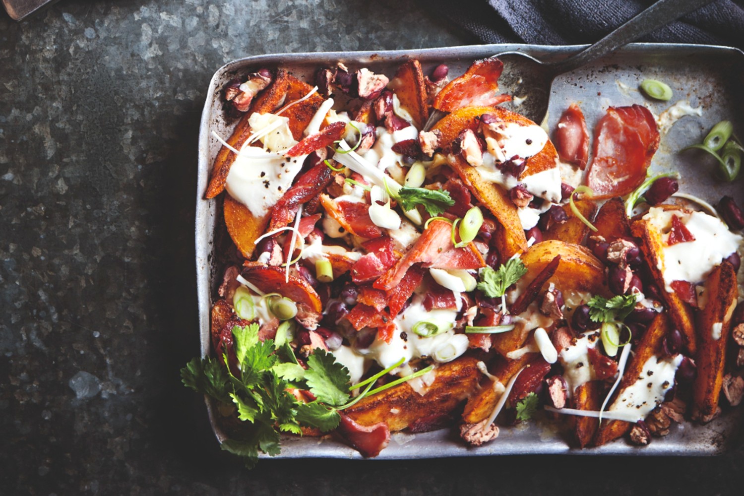 Loaded potato wedges with beans, bacon and cheese