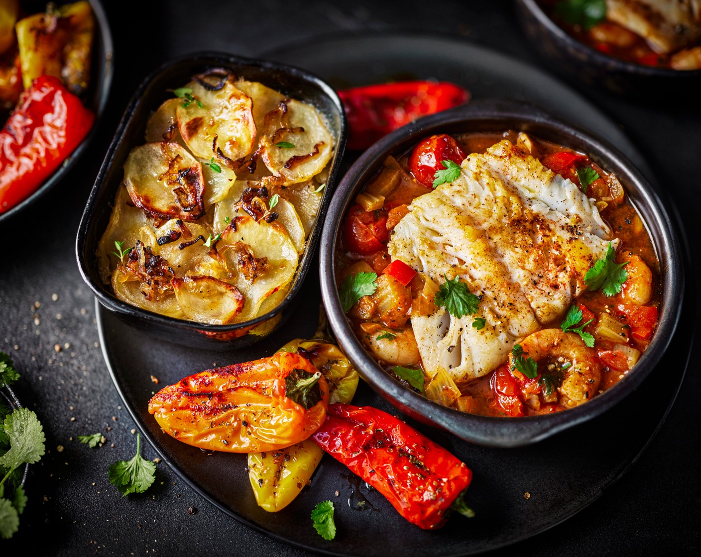 step 11 To serve, spoon the bouillabaisse sauce and prawns into the centre of the plate, place the cod on top, drizzle with extra olive oil, and serve the roasted baby peppers and potatoes on the side.