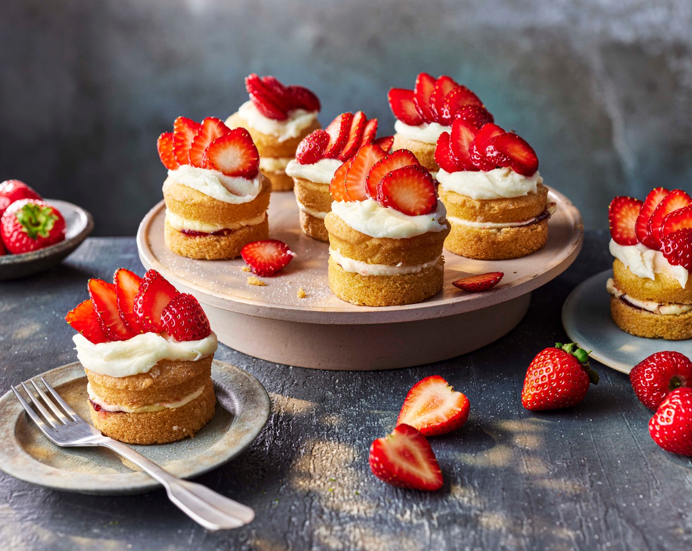 step 2 Spoon onto the cupcakes (4) then top with the sliced strawberries (200 g) to serve.
