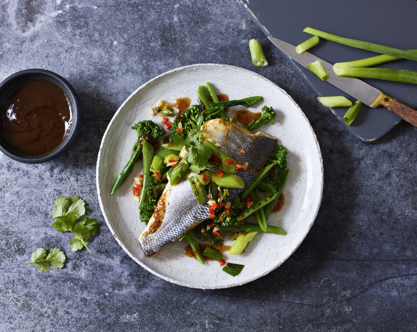 step 8 Add the soy sauce (1 tbsp) and remove from the heat. Drizzle over the sea bass parcel and top with coriander leaves (1 handful) to serve.