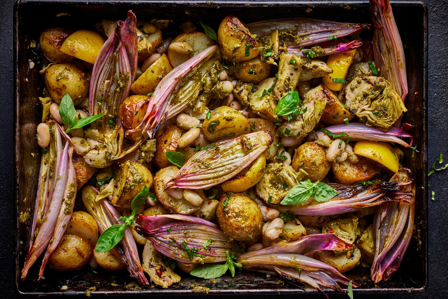 Vegan new potato, lemon, pesto, artichoke and white bean traybake recipe