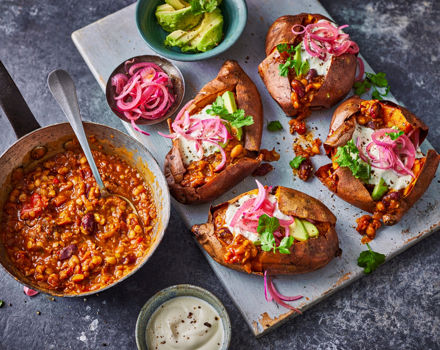 step 7 Slice the avocado (2) and dress in the juice of one lime (1). Serve the chilli in the baked sweet potato jackets with avocado and pickled onions (1 tbsp) on top, plus extra lime wedges (1).