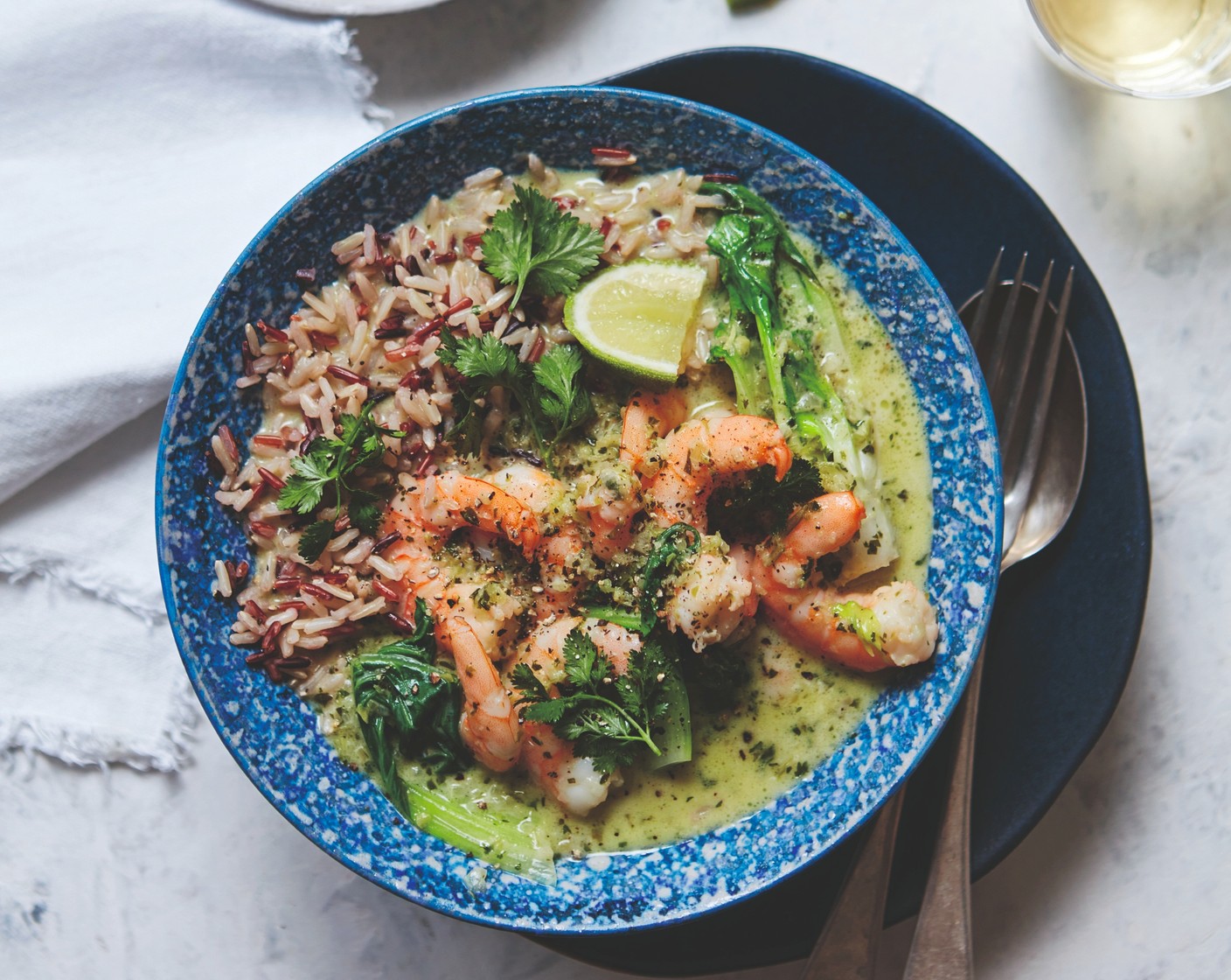 step 3 Add the stalks of the pak choi (90 g), reserving the leaves, along with the prawns (1 pack). Simmer for another 3 minutes or until the prawns are cooked. Stir in the pak choi leaves and the lime juice (2). Season to taste. Serve with the cooked rice and lime wedges.