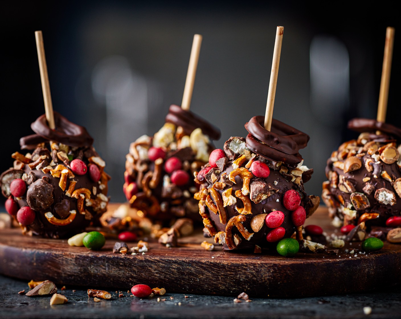 step 6 With the leftover chocolate, dip the pretzels from the merry munch, into the chocolate and thread it through the skewer. Place the apples back on the tray and leave to set in the fridge for an hour.