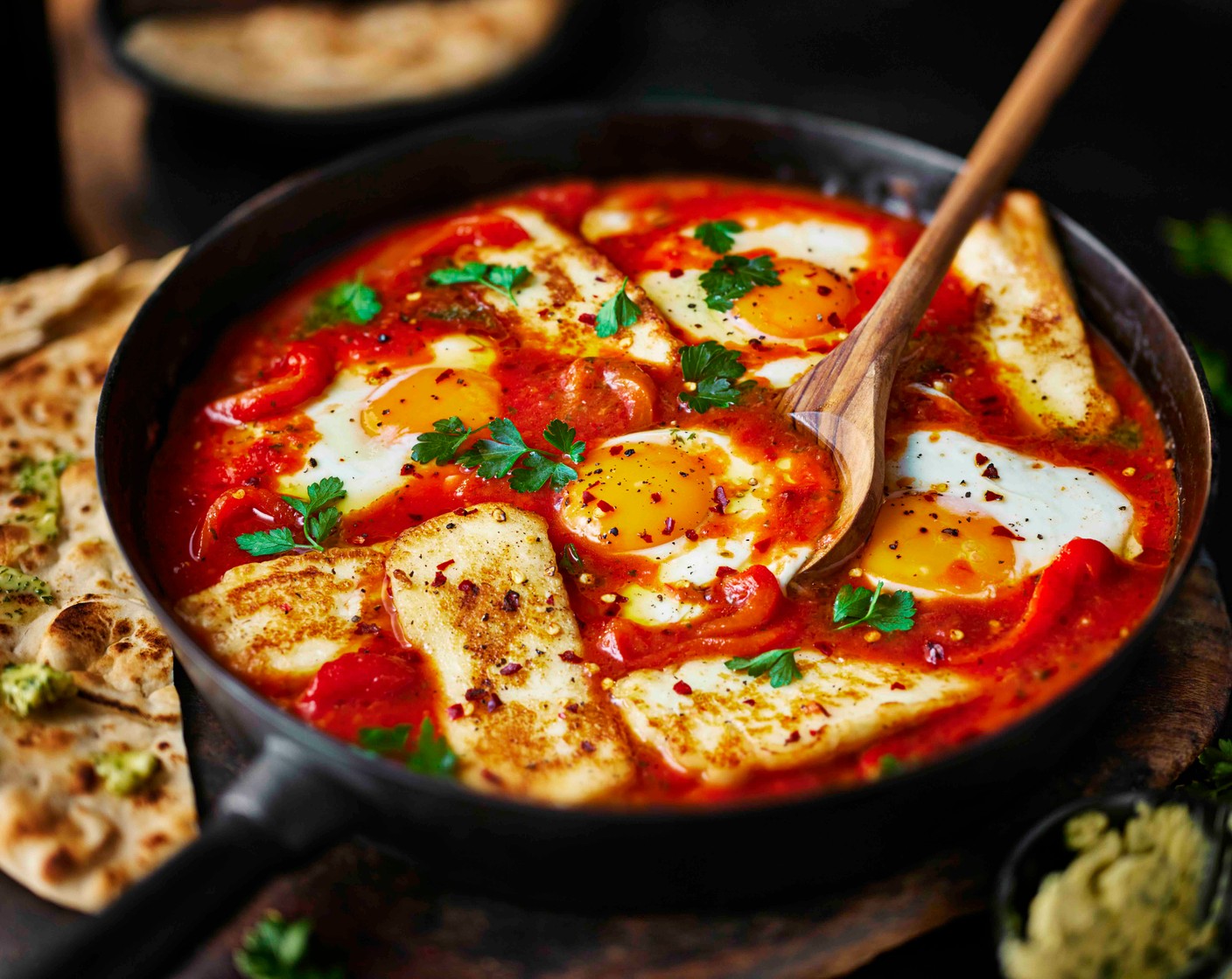 step 5 While the eggs are cooking, heat a small splash of oil in a separate griddle pan over a medium heat and add the halloumi slices (250 g). Pan-fry for 2-3 minutes on each side until golden brown. Nestle the halloumi slices into the pan with the eggs and warm through for 2 minutes. Scatter with the parsley (5 g). Serve with the flatbreads.