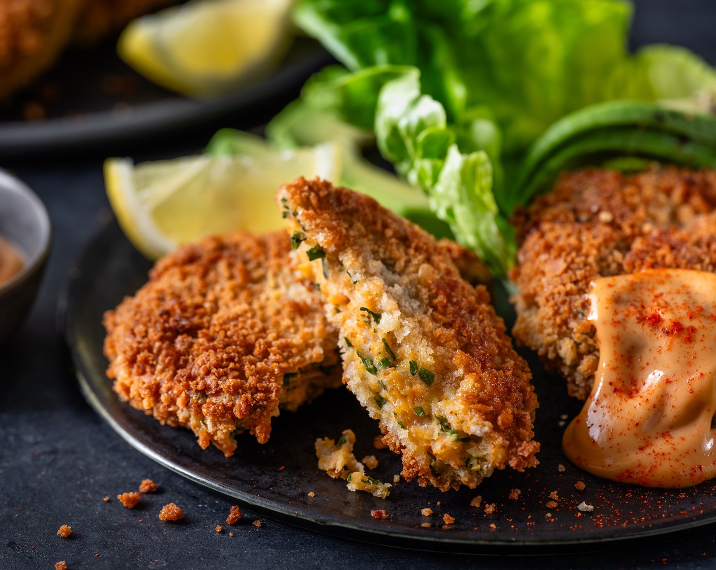 step 5 While the prawn cakes cook, add some lettuce (1 pack) to a plate and top with the thinly sliced avocado (1). Pop the prawn cocktail cakes on top and serve with a generous dollop of seafood sauce (4 tbsp), a pinch of smoked paprika (1 pinch), and the lemon wedges (1).