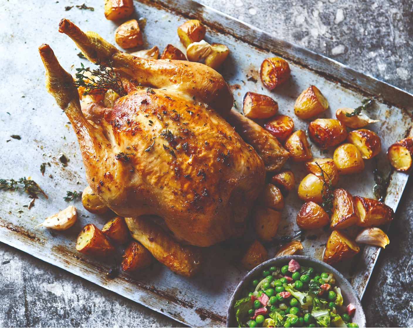 step 4 To serve, carve the chicken and plate up along with the peas and potatoes, and pour the resting juices from the chicken over.