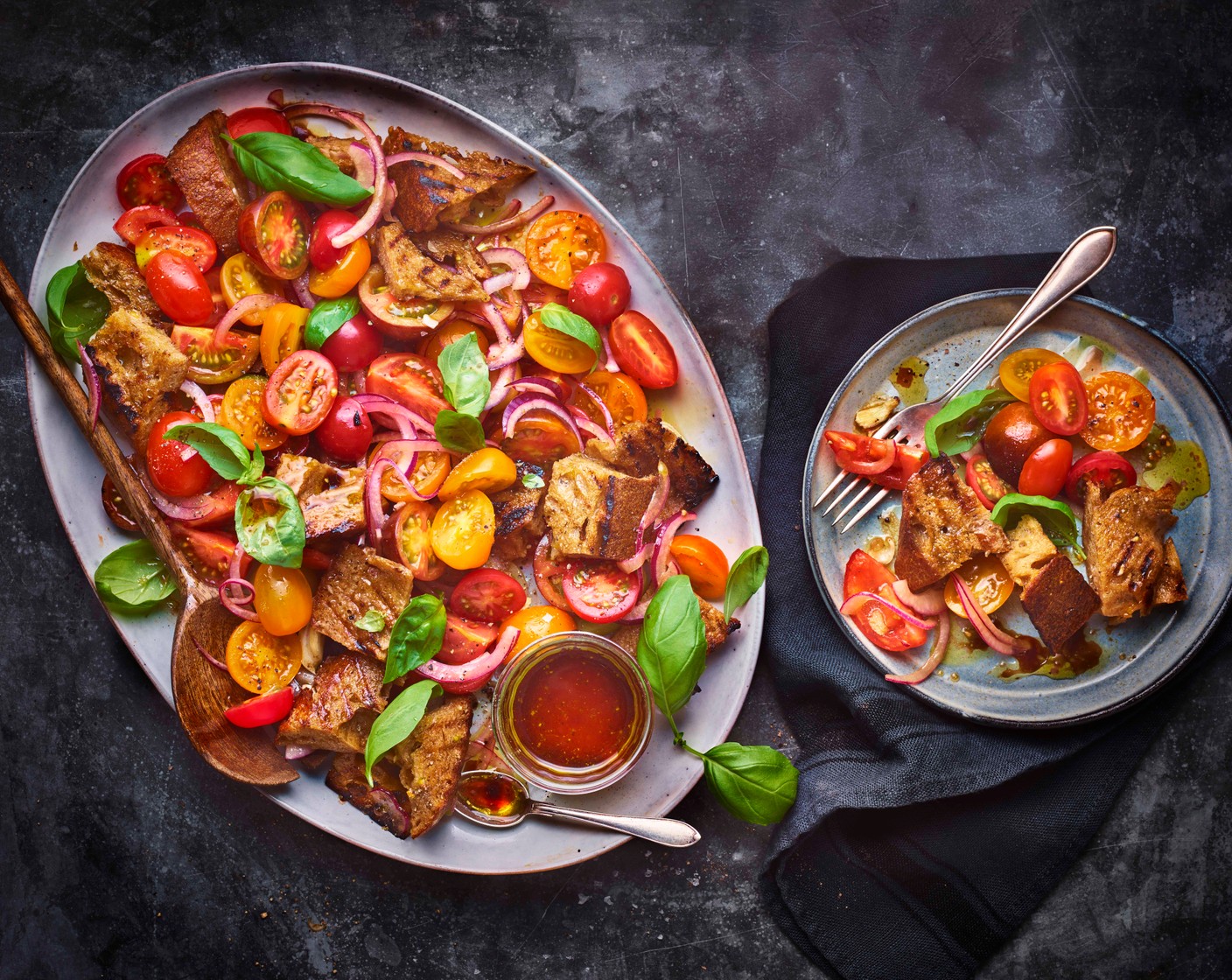 step 4 When ready to serve, add the bread, Santini tomatoes (600 g), tomatoes (3), onion (1) and most of the basil leaves (1 handful) to the bowl with the dressing. Season and mix well. Divide between serving bowls and garnish with the remaining basil leaves.