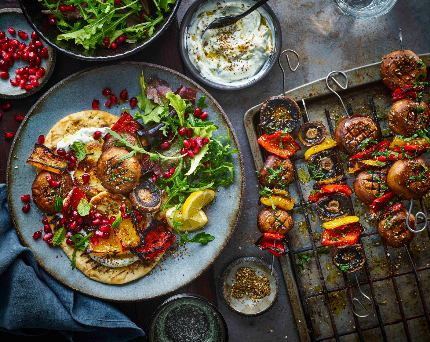 step 6 Serve the flatbreads and kebabs alongside the salad leaves (50 g) and mint leaves (1 handful), drizzled with a little extra virgin olive oil and lemon juice (1/2) and scattered with pomegranate seeds (4 tbsp).