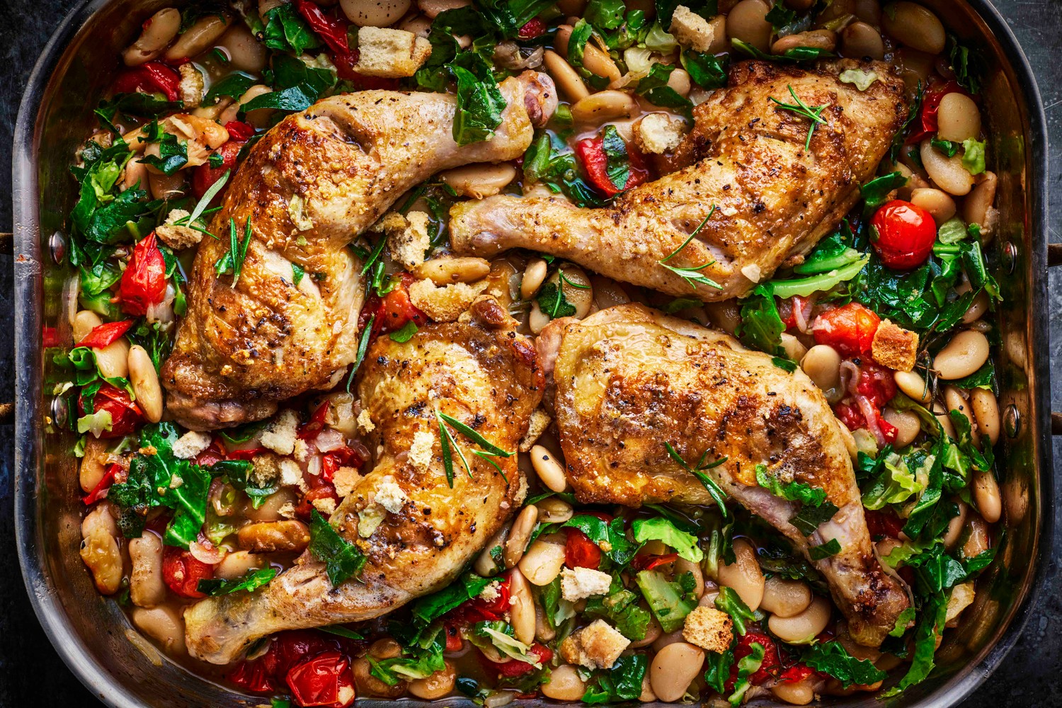 Rosemary roasted chicken legs with butterbeans, greens and anchovy butter