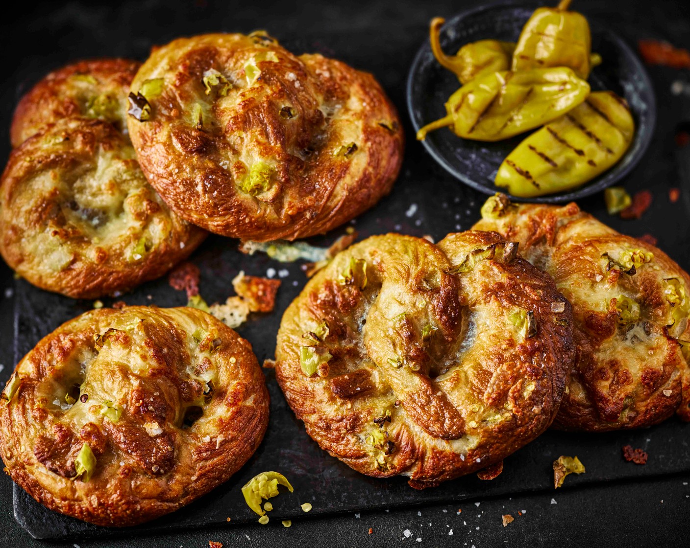 step 9 Brush with beaten egg (1), scatter over the reserved pepperoncini and bake for 10 minutes. Add the cheddar (120 g) and return for another 10 minutes until golden and melted.