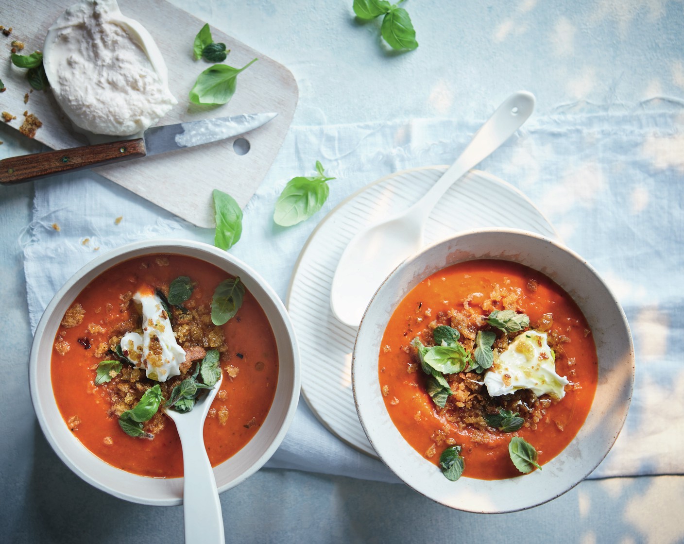 step 6 Ladle the soup into serving bowls. Serve each topped with some torn burrata (1), the breadcrumbs and the fresh oregano and basil (1 handful) (if using). Drizzle with a little olive oil.